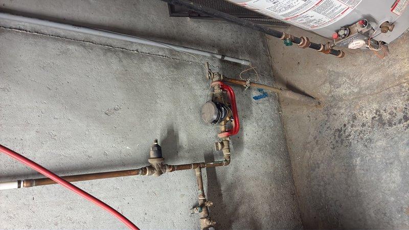Performed comprehensive inspection of Bradford White 40-gallon gas water heater (Model MI40T6BN) in basement. Verified unit specifications, examined gas connections, pressure relief valve, and copper supply line shut-off valves. Assessed existing plumbing infrastructure for kitchen water line addition, including evaluation of hot and cold water distribution system with accessible shut-off points. Documented equipment condition and existing plumbing configuration to provide repair and installation recommendations.