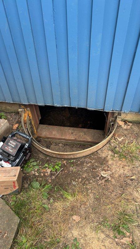 Responded to main drain line blockage caused by root intrusion. Located cleanout access point at exterior crawl space entry beneath structure. Successfully cleared root mass from main drain line using mechanical auger equipment. Verified proper flow restoration through drainage system. Documented existing corrosion on exposed plumbing components in crawl space area for future reference.