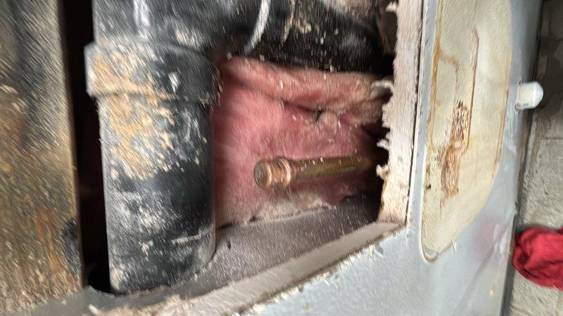 Responded to a leaking water line cap in the bathroom area. Upon inspection, located the compromised copper water line with a failing cap that was allowing water seepage. Removed the defective cap and properly capped off the water line using appropriate brass fittings to ensure a watertight seal. Verified the repair held pressure and confirmed no additional leaks were present in the immediate plumbing system. Work area was accessed through confined space requiring careful maneuvering around existing HVAC ductwork and framing.