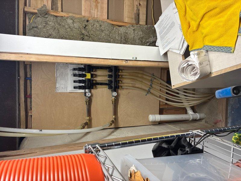 Conducted on-site evaluation for tankless water heater and boiler installation. Assessed existing plumbing infrastructure including PEX manifold distribution system with multiple zone lines, documented HVAC control panel wiring and terminal connections, and photographed current equipment configuration to develop comprehensive installation estimate for new heating system components.