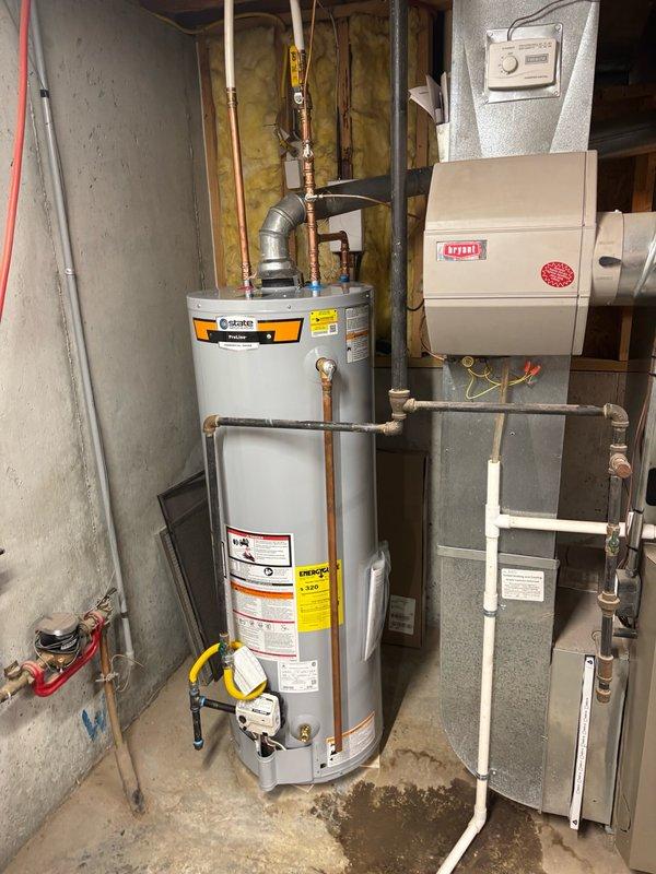Completed installation of a 40-gallon gas-fired water heater in basement utility area. Installed thermal expansion tank to protect plumbing system from thermal expansion pressure, mounting it horizontally on the cold water supply line. Configured all copper piping connections to tank inlet and outlet with appropriate brass fittings, including temperature and pressure relief valve discharge piping per code requirements. Verified all gas connections, tested for leaks, and confirmed proper venting. System was filled, purged of air, and tested for proper operation with no leaks detected.
