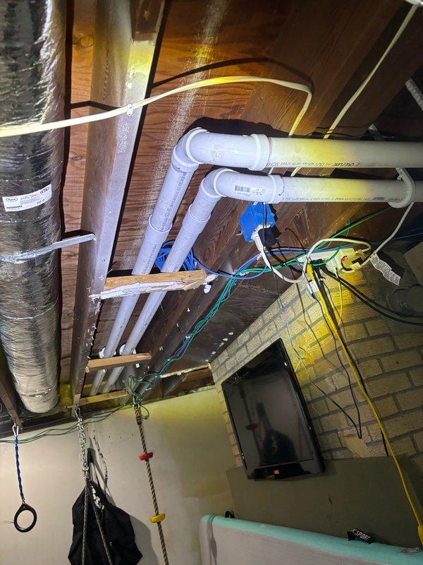 Completed preventative plumbing maintenance inspection on residential property. Accessed attic crawl space to inspect drainage system including PVC trap configuration and verified proper installation and labeling of all plumbing lines. Inspected tankless water heater unit, removed front cover panel to examine internal components including heat exchanger assembly, control board, electrical connections, and verified all inlet/outlet plumbing connections and shut-off valves are functioning properly.