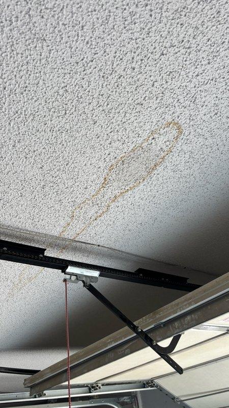 Responded to water leak investigation at residential property with damp drywall ceiling in garage directly below spare full bathroom. Homeowner reported discovering moisture after using bathtub with shower head to wash dog, a fixture rarely utilized in normal household routine. Upon arrival, conducted systematic inspection of bathroom plumbing components including visual examination of supply line shutoff valves, tile surrounds, and tub drain assembly. Confirmed no visible leaks at shutoff valves, dry tile conditions, and absence of audible dripping sounds. Verified water meter showed no movement with all fixtures in off position, ruling out active supply line leak at time of inspection.

Identified rusted chip in metal flange of tub drain assembly during close examination, noting this as potential compromise point in drainage system integrity. Documented persistent ceiling dampness hours after initial water usage, indicating slow leak or trapped moisture condition. Photographically do