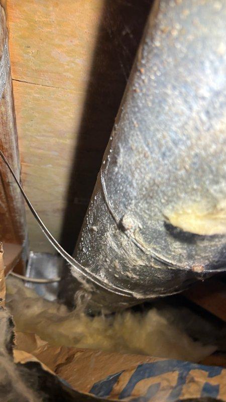 Responded to water leak investigation at residential property with damp drywall ceiling in garage directly below spare full bathroom. Homeowner reported discovering moisture after using bathtub with shower head to wash dog, a fixture rarely utilized in normal household routine. Upon arrival, conducted systematic inspection of bathroom plumbing components including visual examination of supply line shutoff valves, tile surrounds, and tub drain assembly. Confirmed no visible leaks at shutoff valves, dry tile conditions, and absence of audible dripping sounds. Verified water meter showed no movement with all fixtures in off position, ruling out active supply line leak at time of inspection.

Identified rusted chip in metal flange of tub drain assembly during close examination, noting this as potential compromise point in drainage system integrity. Documented persistent ceiling dampness hours after initial water usage, indicating slow leak or trapped moisture condition. Photographically do