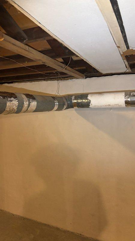 Conducted site assessment in basement crawlspace area to provide estimate for water heater exhaust pipe replacement and main drain augering service. Inspected existing plumbing infrastructure, including drainage systems and water heater venting configuration in unfinished utility space with exposed floor joists and concrete foundation. Documented current conditions of mechanical systems and access points for proposed piping work and drain cleaning procedures.