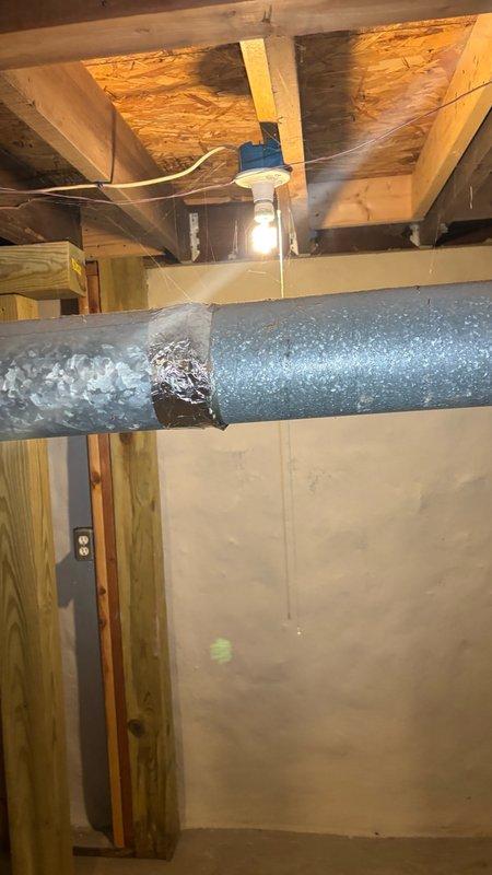 Conducted site assessment in basement crawlspace area to provide estimate for water heater exhaust pipe replacement and main drain augering service. Inspected existing plumbing infrastructure, including drainage systems and water heater venting configuration in unfinished utility space with exposed floor joists and concrete foundation. Documented current conditions of mechanical systems and access points for proposed piping work and drain cleaning procedures.