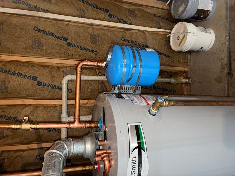 Installed a new 3/4" pressure reducing valve (PRV) on the main water supply line to regulate incoming water pressure and protect the plumbing system from excessive pressure damage. Additionally, installed a thermal expansion tank on the water heater system to accommodate thermal expansion of heated water and prevent pressure buildup that could damage fixtures and appliances. Both installations were completed with proper copper pipe connections and shutoff valves for future serviceability.
