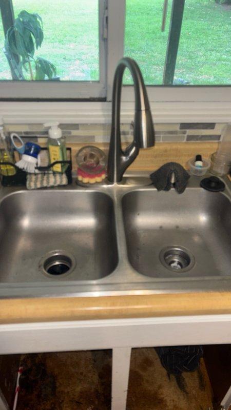 Responded to service call for non-draining kitchen and hall bathroom sinks. Upon arrival, performed diagnostic assessment of both fixtures. Executed professional drain cleaning procedures on the kitchen double-basin stainless steel sink and hall bathroom vanity sink to restore proper drainage. Cleared blockages from drain lines using appropriate drain cleaning equipment and techniques. Tested both fixtures post-service to verify full water flow and proper drainage function. All drains now operating within normal parameters.