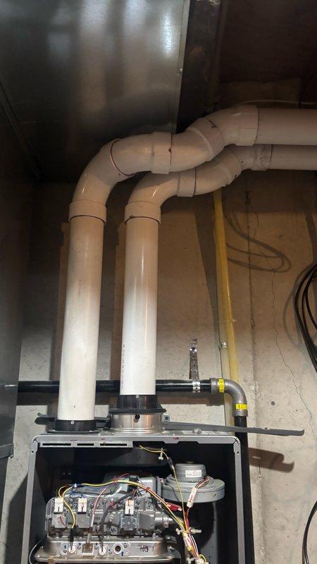 Responded to service call for non-operational tankless water heater in basement that had been previously disassembled by another plumber. Upon arrival, found 11-year-old gas-fired tankless unit with front panel removed and internal components exposed, including heat exchanger, gas burner manifold, copper water circulation piping, and electrical connections. Performed thorough assessment of unit condition and photographed existing installation showing PVC exhaust venting, yellow flexible gas supply lines, shut-off valves, and various connection points. Evaluated whether unit could be repaired or required full replacement. Explained difference between estimate service and diagnostic service call, with customer agreeing to proceed with comprehensive evaluation to determine most appropriate course of action for restoring hot water service.