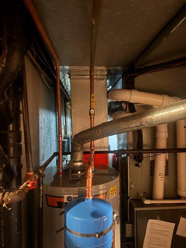Completed installation of a 50-gallon gas water heater in the mechanical room with all required connections and safety components. Installed thermal expansion tank to protect the system from pressure buildup caused by thermal expansion within the closed plumbing system. Configured all copper supply lines, gas connections, and venting per manufacturer specifications and local code requirements. Verified proper operation of temperature and pressure relief valve, confirmed adequate combustion air supply, and tested all connections for leaks. System commissioned and left in full operational status.