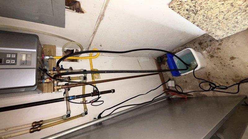 Replaced faulty service ports on tankless water heater combustion fan assembly. Verified system pressure readings within manufacturer specifications and confirmed proper gas line connections. Unit tested and returned to normal operation with all safety parameters met.