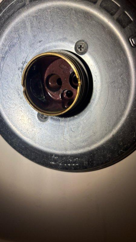 Responded to bathroom faucet dripping issue. Disassembled shower/tub control valve assembly, exposing corroded internal cartridge and brass components with visible rust buildup. Replaced faulty cartridge mechanism and reassembled valve stem with new hardware, restoring proper water shut-off function and eliminating the drip.
