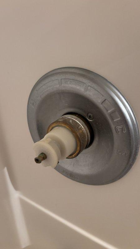 Responded to bathroom faucet dripping issue. Disassembled shower/tub control valve assembly, exposing corroded internal cartridge and brass components with visible rust buildup. Replaced faulty cartridge mechanism and reassembled valve stem with new hardware, restoring proper water shut-off function and eliminating the drip.
