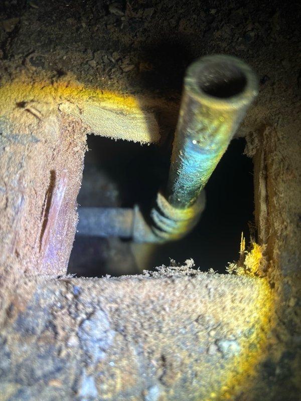 Responded to emergency call for ruptured toilet supply line on second floor. Upon arrival, found active water leak from failed supply line connection causing significant water damage to ceiling below. Immediately shut off water supply to affected fixture to prevent further damage. Assessed extent of damage, which included substantial water intrusion through floor penetration resulting in ceiling deterioration with visible cracking, staining, and material separation on lower level. 

Removed damaged supply line and inspected connection points for corrosion or deterioration. Installed new braided stainless steel supply line with proper torque specifications and verified all connections for leaks. Restored water supply and conducted pressure test to ensure system integrity. Documented water damage to ceiling and surrounding areas for insurance purposes. Advised property owner of need for professional water damage remediation and ceiling repair by qualified contractor.