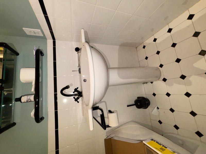 Responded to reported leak at exterior hose spigot at rear of property. Upon arrival, inspected outdoor faucet and confirmed active leak when valve was in open position. Located and identified main water shutoff valve for property and demonstrated operation to occupant. Additionally, inspected interior bathroom plumbing fixtures including wall-mounted faucet assembly with cross-handle controls and verified proper operation of sink drainage system. All accessible plumbing connections were checked for signs of moisture or deterioration.