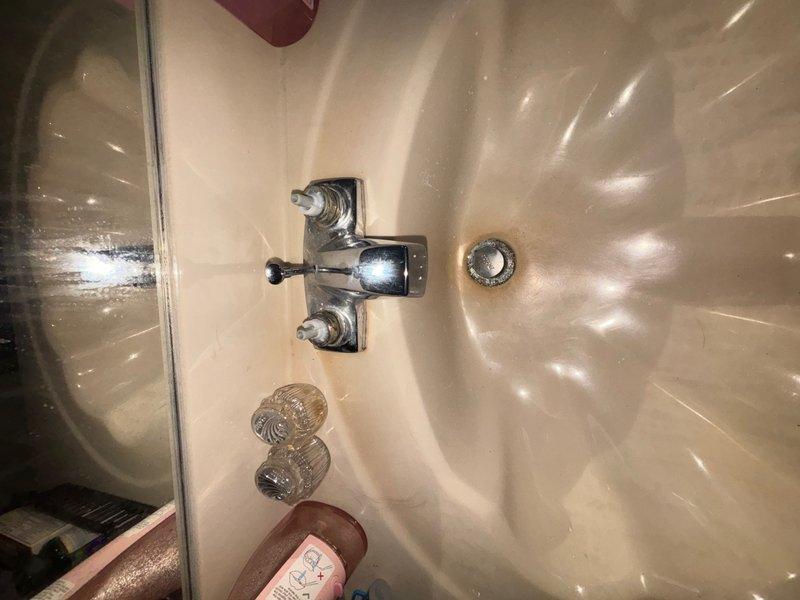 Completed plumbing repair involving the replacement of a worn faucet stem on a bathroom sink fixture with traditional cross-handle design. Successfully installed a 3/4-inch pressure reducing valve (PRV) on the main water supply line using proper copper piping connections with compression fittings to regulate incoming water pressure and protect household plumbing fixtures from potential damage caused by excessive pressure.