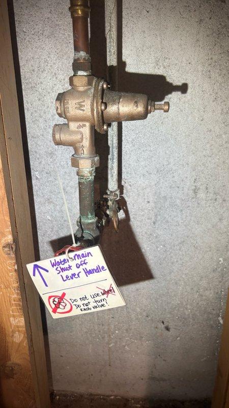 Completed plumbing maintenance inspection including tankless water heater system flush and comprehensive facility assessment. Inspected and documented floor drain/sump pit assembly with monitoring equipment in place, verified proper drainage function and water levels. Evaluated main water shutoff valve assembly with pressure regulator, confirmed proper operation of brass valve body and shutoff lever handle, documented existing safety labeling for watermain controls.