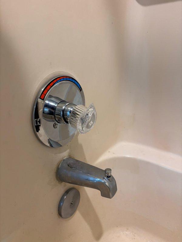 Responded to service call for master bathroom faucet repair. Upon arrival, inspected the bathtub faucet assembly which included a chrome-plated tub spout and single-handle shower/bath control valve with temperature indicator dial. Assessed the fixture's condition and functionality, documented the existing installation with chrome finishes and acrylic handle mechanism. Completed necessary repairs to restore proper faucet operation in the master bathroom.