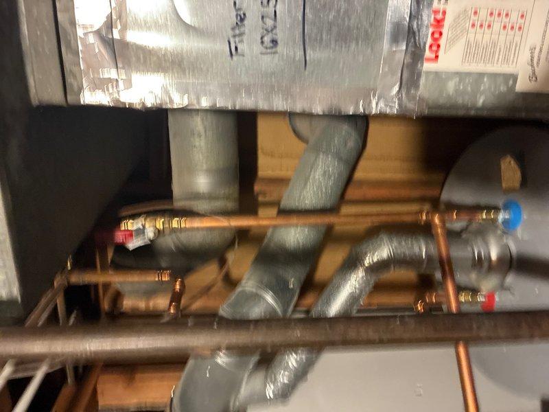 # Plumbing Inspection Summary

Completed comprehensive whole home plumbing inspection examining all accessible water supply lines, drain systems, and fixtures. Inspected mechanical room containing HVAC equipment with multiple copper supply lines, hot and cold water distribution piping with appropriate color-coded indicators, and gray insulated ductwork in basement/crawl space area. Evaluated under-sink plumbing including flexible braided water supply lines, white PVC drain assembly with P-trap configuration, and cabinet conditions. All plumbing components photographed and documented for customer records.
