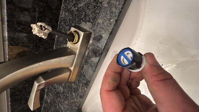 Responded to reported cold water faucet leak in common bathroom. Upon inspection, assessed plumbing fixtures and water supply connections. Examined water heater installation in attic space, including copper supply lines and drainage components. Replaced faulty valve component to resolve leak issue and ensure proper water flow control.
