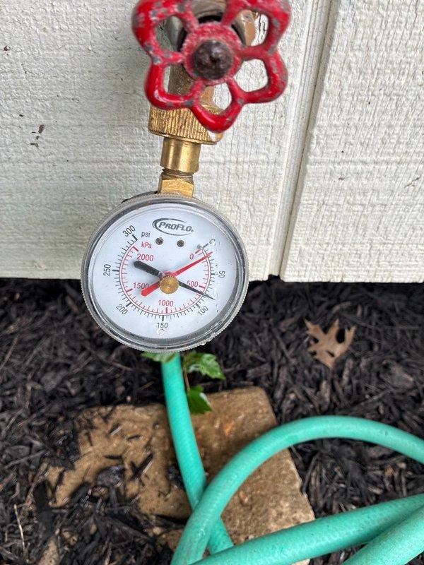Completed plumbing maintenance inspection and system evaluation. Inspected tankless water heater installation including water supply lines, gas connections, shut-off valves, and flexible braided stainless steel supply hoses. Verified proper operation of blue and red-handled ball valves, brass fittings, and manifold connections. Tested exterior water pressure using gauge, confirming system pressure within normal operating parameters. All components found in functional condition with no leaks detected.