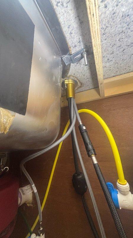 Installed customer-provided Kohler faucet in kitchen. Connected hot and cold water supply lines using braided stainless steel flex lines with proper fittings, ensuring secure connections to existing under-sink plumbing. Verified all connections for leaks and confirmed proper operation of new faucet installation.