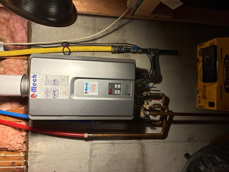 Performed annual preventive maintenance on iTech tankless water heater system, including complete system flush to remove mineral buildup and ensure optimal performance. Inspected all water connections, gas lines, and electrical components for proper operation and safety compliance. Verified proper function of hot and cold water isolation valves with blue and red handles on the copper manifold assembly. Tested unit controls, digital display, and operational settings. Confirmed adequate venting and clearances around the unit. System operating within manufacturer specifications upon completion.