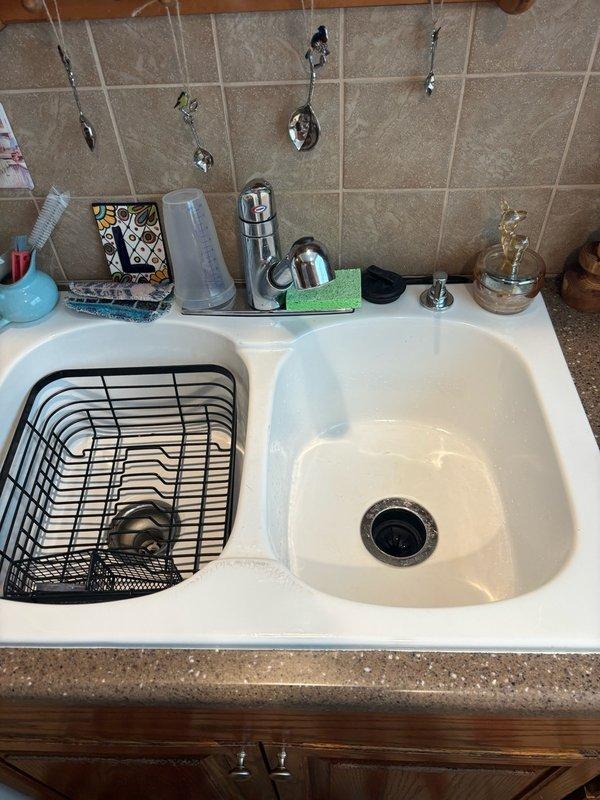 Replaced garbage disposal unit in kitchen sink with new blue model, securing mounting flange and connecting electrical supply. Investigated reported low water pressure issue at kitchen sink faucet, inspecting supply lines and aerator for blockages or restrictions. Verified proper drainage through P-trap configuration and tested disposal operation to ensure functionality.