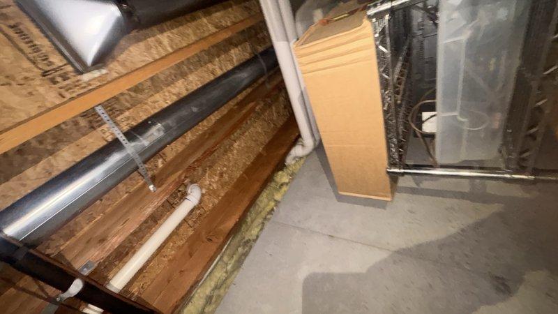 Completed comprehensive plumbing system inspection in basement and attic mechanical spaces. Evaluated condition of water supply lines, drain piping, and associated fixtures including PVC drainage systems, aged metal supply piping with brass fittings, and verified proper clearances around HVAC equipment. All accessible plumbing components were visually inspected and documented photographically for customer records.