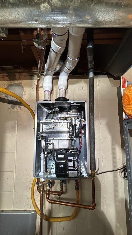 Completed warranty tankless water heater swap-out in residential utility space. Removed existing unit and installed customer-supplied replacement, requiring modification of copper supply lines to achieve proper mounting height and alignment. Reconnected all water ports, gas line, and venting system, ensuring secure connections and proper clearances per manufacturer specifications.