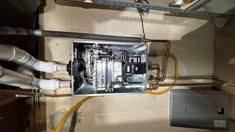 Completed warranty tankless water heater swap-out in residential utility space. Removed existing unit and installed customer-supplied replacement, requiring modification of copper supply lines to achieve proper mounting height and alignment. Reconnected all water ports, gas line, and venting system, ensuring secure connections and proper clearances per manufacturer specifications.