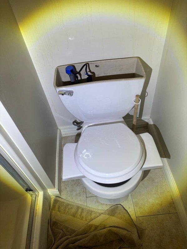 Completed routine plumbing maintenance inspection and evaluated existing toilet installation in residential bathroom for potential replacement. Inspected toilet tank components including float valve mechanism and flush handle assembly, examined water supply line connections and shut-off valve operation, and documented current plumbing configuration. Provided replacement quote as requested for toilet replacement consideration.