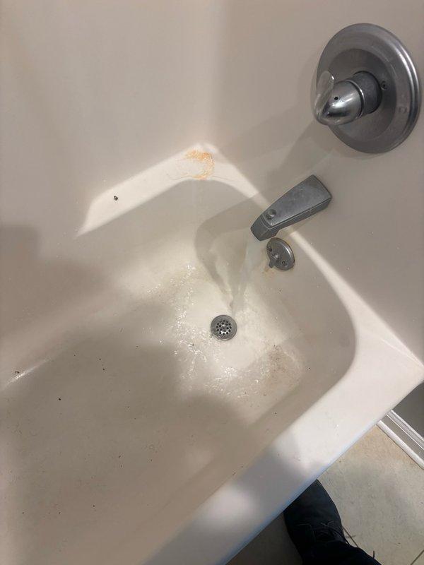 Responded to a clogged drain issue affecting the main level bathroom shower and sink. Upon arrival, inspected the bathtub and drain assembly, noting water pooling and drainage concerns. Assessed the fixture conditions, documented existing staining and mineral buildup on the tub surface, and evaluated the drain opening and surrounding plumbing components. Cleared the obstruction from the drain line to restore proper water flow and drainage function. Verified system operation upon completion.
