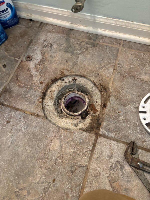 Responded to service call for clogged toilet on main level hallway bathroom. Upon arrival, assessed the toilet fixture and surrounding plumbing system. Successfully cleared the obstruction using appropriate drain clearing equipment and techniques. Verified proper flushing operation and drainage flow upon completion. Also inspected floor drain in bathroom, noting significant rust and corrosion present on drain fixture requiring future attention. Tested toilet multiple times to ensure complete resolution of blockage and confirmed system returned to normal working condition.