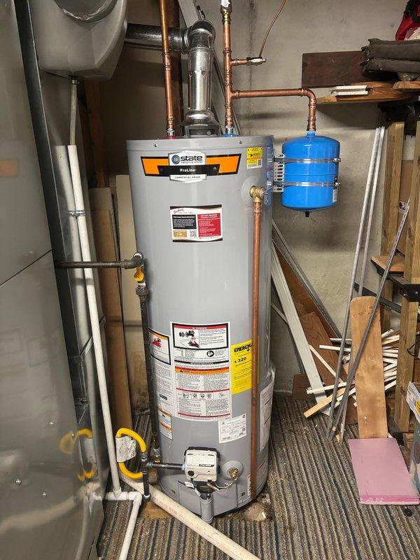 Installed a new 40-gallon State brand gas water heater with thermal expansion tank in the mechanical room. All copper supply lines were properly connected with brass fittings and shutoff valves, gas line was installed with appropriate shutoff valve, and the blue thermal expansion tank was mounted and plumbed according to code requirements to protect against thermal expansion in the closed water system.