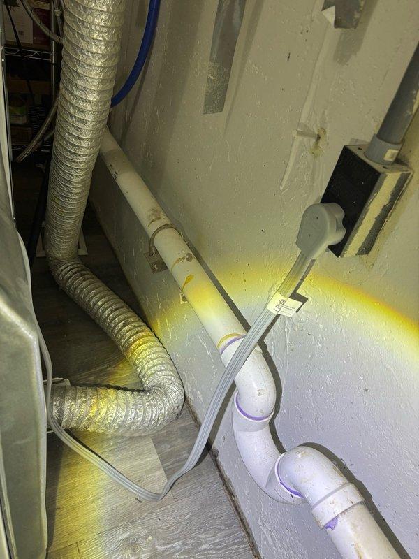 Responded to complaint of bathroom sink backing up when washing machine drains. Upon inspection, identified drainage issue in shared waste line serving both washing machine and nearby bathroom fixtures. Located problematic plumbing configuration in basement utility area where washing machine discharge connects to main drain stack. Cleared obstruction from horizontal drain line using appropriate mechanical methods. Verified proper drainage flow from washing machine through PVC drainage system and confirmed bathroom sink now drains freely without backup during washing machine operation. Tested system through multiple cycles to ensure complete resolution of cross-fixture drainage problem.