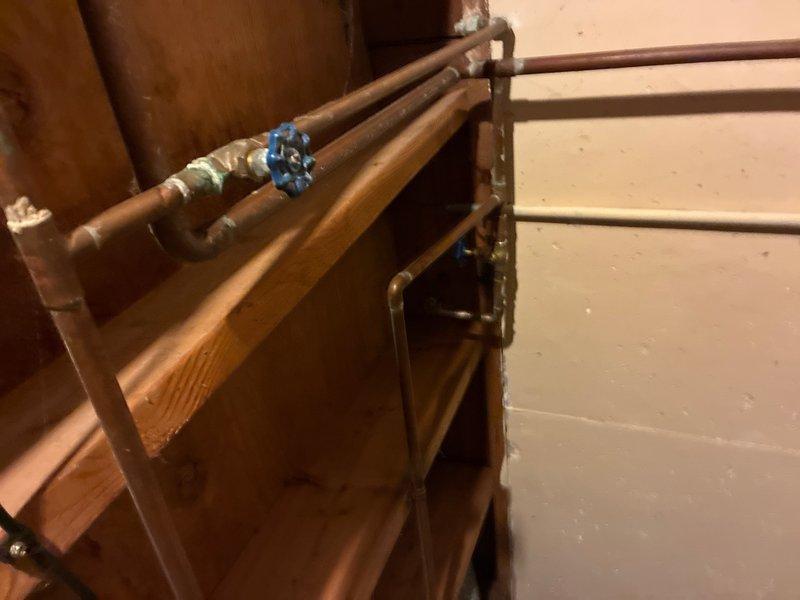 Completed recurring plumbing maintenance inspection of residential copper piping system in basement utility area and bathroom wall cavity. Verified proper operation of shut-off valves, inspected pipe connections and fittings for leaks or corrosion, and documented existing plumbing infrastructure condition with photographic records for maintenance tracking purposes.