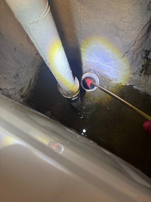 Responded to clogged floor drain in basement. Upon inspection, located the drainage system and assessed the blockage situation. Cleared the obstruction from the floor drain line and verified proper water flow through the system. Inspected related drainage components including exterior downspout connections and mechanical space plumbing to ensure no additional blockages or issues were present. System restored to full functionality with proper drainage confirmed.