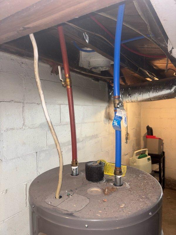Responded to no hot water complaint at residential property. Performed diagnostic assessment of gas water heater located in basement utility area. Conducted visual inspection of unit and associated plumbing connections, including hot and cold water supply lines (PEX piping with brass fittings). Documented existing water heater configuration and current condition through photographic records. Provided estimate for water heater repair or replacement options to restore hot water service to the residence.