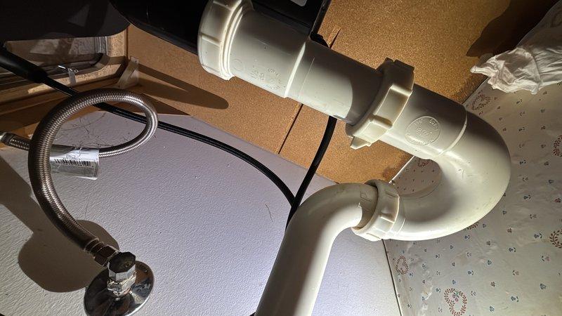 Responded to kitchen garbage disposal leak at electrical connection point. Upon inspection, identified active leaking at the power cord entry location on the disposal unit. Removed and replaced the garbage disposal unit with new installation. Reinstalled drain connections with new P-trap assembly and properly secured all plumbing fittings to ensure watertight seals. Connected electrical power cord and verified unit operation. Tested system for leaks and confirmed proper drainage and disposal function.