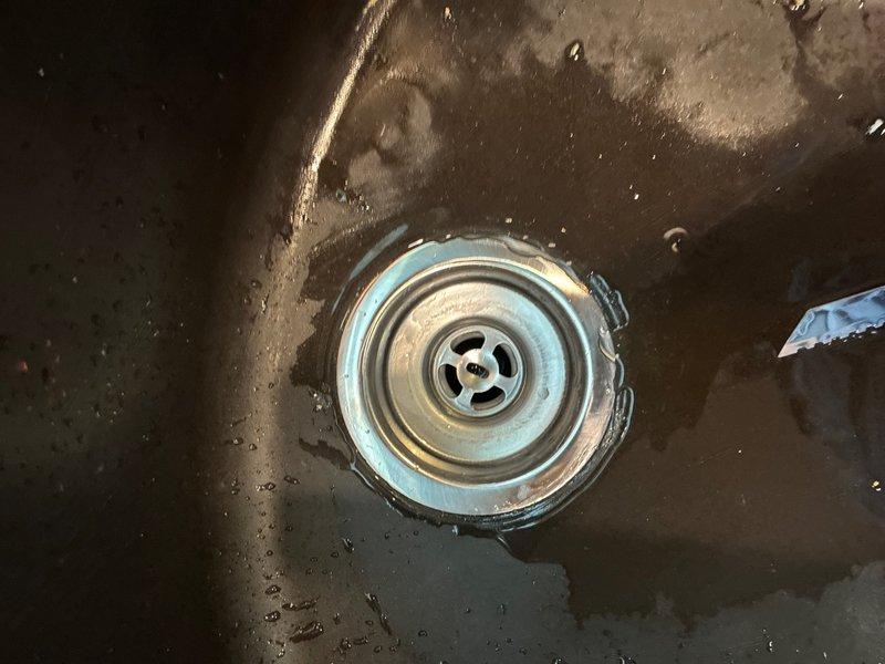 Responded to report of water leaking under kitchen sink. Upon inspection, identified deteriorated PVC drain pipe with significant staining and mineral buildup at connection point beneath sink basin. Replaced damaged section of drain pipe and connection fittings, ensuring proper seal to eliminate leak. Tested drain system for proper flow and verified no additional leaks present. Work completed successfully with system restored to normal operation.