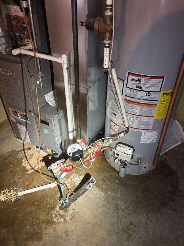 Installed a new 40-gallon State ProLine gas water heater in basement utility area, replacing existing unit. Installation included proper venting with metallic flue pipe, copper supply line connections with ball valve shutoffs, expansion tank mounting and integration, gas line connection, temperature and pressure relief valve installation, and code-compliant drain pan placement. All connections were tested for leaks, gas supply was verified for proper operation, and unit was fired and brought to temperature to ensure proper functionality.