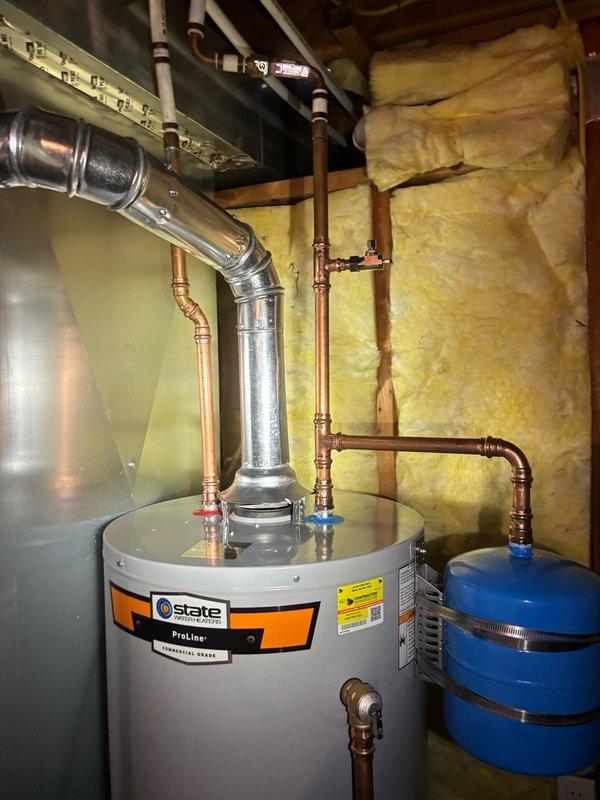 Installed a new 40-gallon State ProLine gas water heater in basement utility area, replacing existing unit. Installation included proper venting with metallic flue pipe, copper supply line connections with ball valve shutoffs, expansion tank mounting and integration, gas line connection, temperature and pressure relief valve installation, and code-compliant drain pan placement. All connections were tested for leaks, gas supply was verified for proper operation, and unit was fired and brought to temperature to ensure proper functionality.