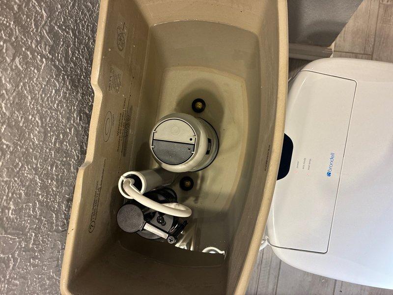 Responded to service call for toilet tank leak and malfunctioning float assembly. Installed customer-supplied replacement parts including new flush valve mechanism, flapper valve system, and float arm assembly. Removed tank lid, replaced worn internal components, and reassembled flushing mechanism to restore proper operation and eliminate water leakage.