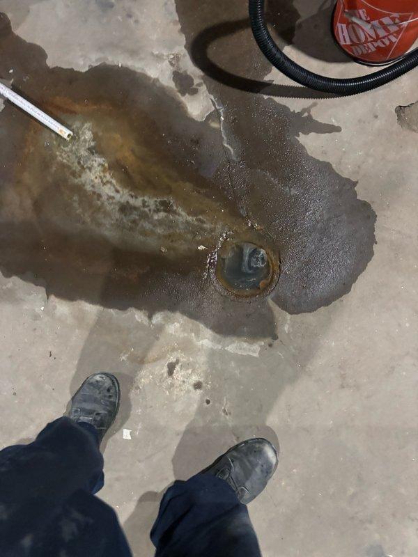 Responded to kitchen sink drain backup that persisted despite homeowner's attempts to clear with a 35-foot snake. Upon arrival, found active drainage issues with water backing up and draining slowly. Deployed professional drain cleaning equipment to thoroughly clear the blockage in the kitchen sink line. Cleared obstruction from the drainage system, restoring proper water flow. Verified drain functionality and confirmed water was flowing freely without backup. Documented basement plumbing infrastructure and floor drain conditions with photographic evidence showing the work area and drainage system components.
