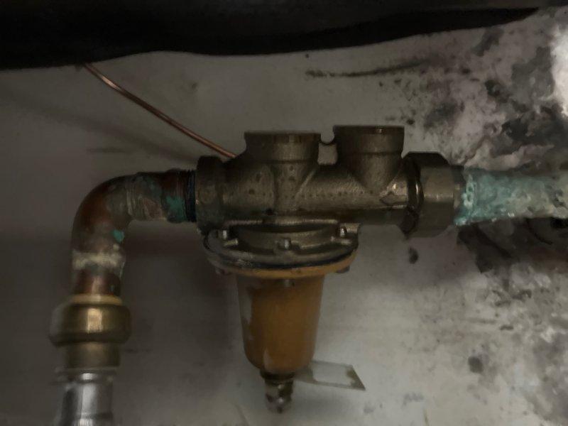 Completed comprehensive whole home plumbing inspection as part of promotional campaign. Thoroughly examined all accessible plumbing systems, fixtures, and connections throughout the property. Inspected main water supply lines, drain systems, shut-off valves, and water heater installation for proper operation and code compliance.

Documented existing conditions in utility areas, noting aged copper piping with visible oxidation and greenish-blue patina on brass fittings, indicating extended service life. Examined filter housing assembly with transparent bowl mounted to horizontal pipe runs in basement area. Assessed compression fittings, elbow joints, and T-junction connections for integrity and potential leak points. Observed corrosion patterns consistent with normal aging on copper and brass components.

Evaluated pipe support systems and insulation conditions in crawl space areas. Inspected ductwork proximity to plumbing lines to ensure proper clearances maintained. Verified no active