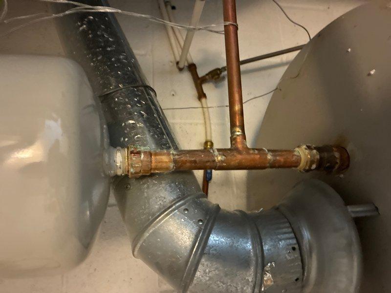 Completed comprehensive whole home plumbing inspection as part of promotional campaign. Thoroughly examined all accessible plumbing systems, fixtures, and connections throughout the property. Inspected main water supply lines, drain systems, shut-off valves, and water heater installation for proper operation and code compliance.

Documented existing conditions in utility areas, noting aged copper piping with visible oxidation and greenish-blue patina on brass fittings, indicating extended service life. Examined filter housing assembly with transparent bowl mounted to horizontal pipe runs in basement area. Assessed compression fittings, elbow joints, and T-junction connections for integrity and potential leak points. Observed corrosion patterns consistent with normal aging on copper and brass components.

Evaluated pipe support systems and insulation conditions in crawl space areas. Inspected ductwork proximity to plumbing lines to ensure proper clearances maintained. Verified no active
