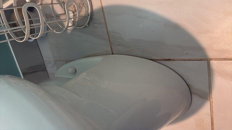 Responded to service call for loose toilet that was moving when used. Upon inspection, found toilet was not properly secured to floor flange. Removed decorative caps and tightened closet bolts to manufacturer specifications. Verified toilet was level and stable with no movement. Checked wax ring seal for proper compression and tested for leaks by flushing multiple times. Confirmed repair resolved mobility issue and toilet now sits firmly in place.