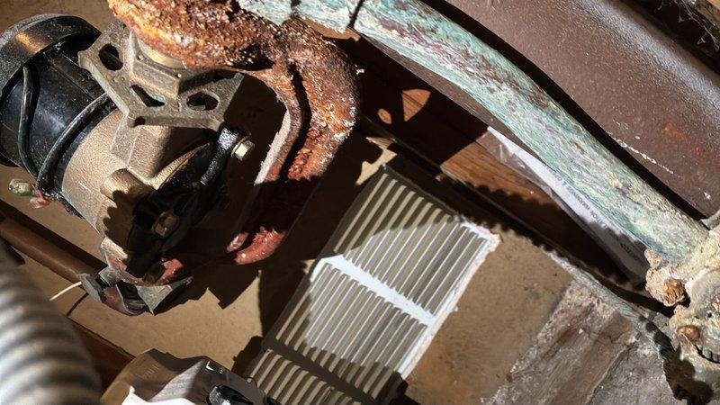Completed comprehensive assessment of deteriorated water main system requiring full replacement. Documented extensive corrosion on existing copper water service line, including severe oxidation with green patina, rust deposits, and mineral buildup concentrated at connection joints. The corroded pipe assembly showed significant degradation that compromised system integrity and posed risk of failure.

Evaluated associated components including brass valve assembly, pump unit, and connecting fixtures, all exhibiting age-related deterioration and corrosion. Provided detailed photographic documentation of all affected plumbing infrastructure to support replacement estimate for complete water main installation.