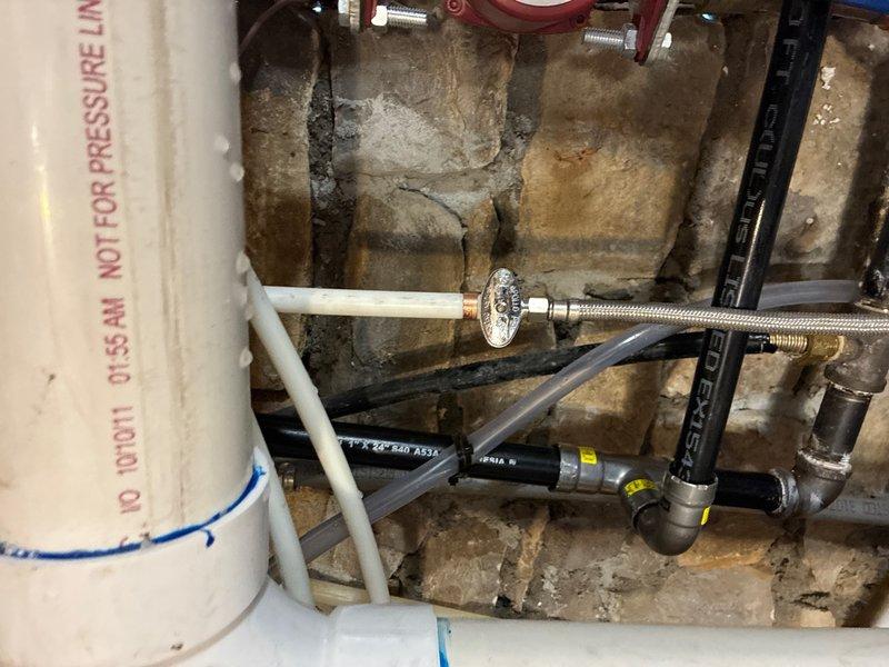 Completed installation of Rinnai RX199 tankless water heater for domestic hot water and NTI FTVN110 boiler system for radiant floor heating. Relocated tankless water heater from original boiler location to exterior wall closet with venting routed through window opening. Connected gas supply line from existing main line at new tankless location and established cold water feed directly from water main. Routed hot water discharge to tie into existing hot water distribution system and configured condensate drain line to discharge at sump pump location. Relocated recirculating pump to new mechanical room housing tankless unit.

Removed existing boiler system and installed replacement NTI FTVN110 boiler with new connection ports integrated to existing radiant floor heating lines. Identified corrosion buildup on circulator pump shut-off valves during removal process and replaced deteriorated valves with new components before reinstalling pump assembly. Installed expansion tank and completed a